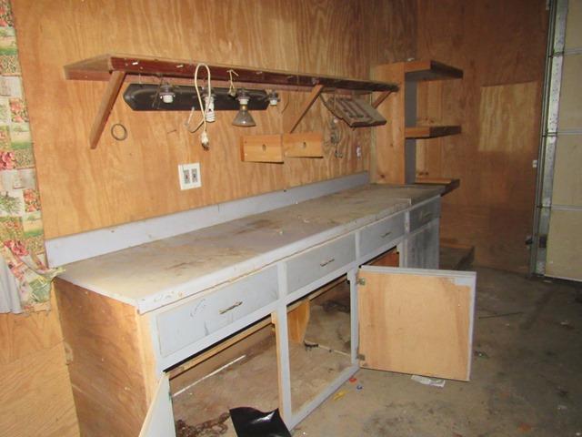 basement featuring wooden walls