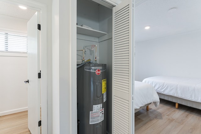 utility room with electric water heater