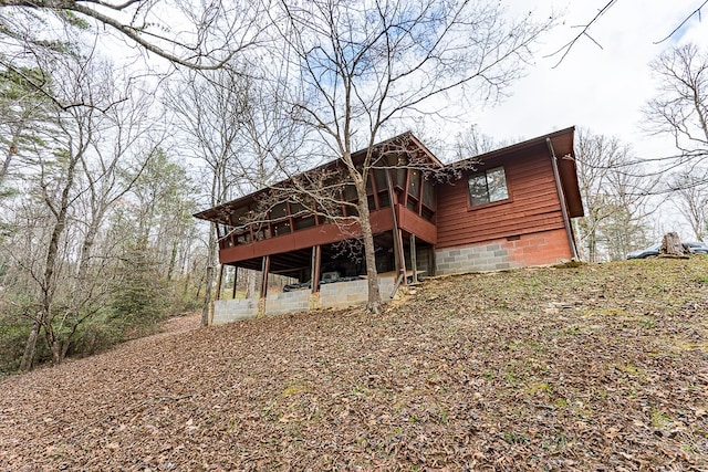 rear view of house featuring a wooden deck