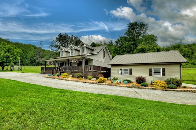 1956 Devils Den Rd, Epworth, GA 30541 - view of front of house featuring a porch, metal roof, and a front lawn