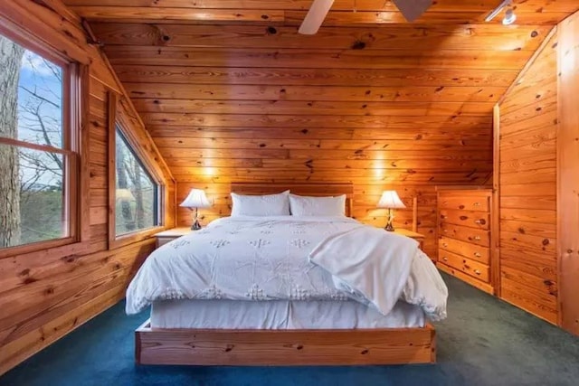 bedroom with vaulted ceiling, wooden ceiling, multiple windows, and dark carpet