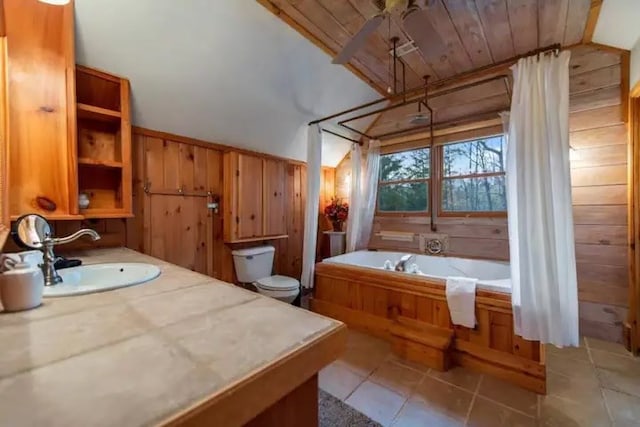 bathroom with wood ceiling, vaulted ceiling, toilet, a washtub, and sink