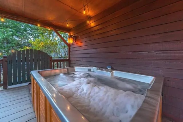 wooden terrace featuring a hot tub