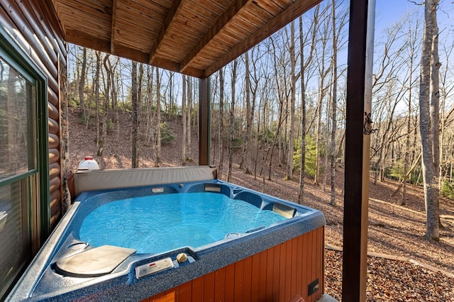 view of swimming pool featuring a hot tub