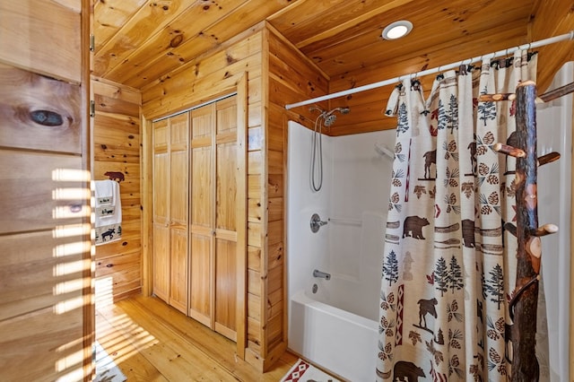 bathroom featuring wooden ceiling, wooden walls, shower / bath combination with curtain, and wood finished floors