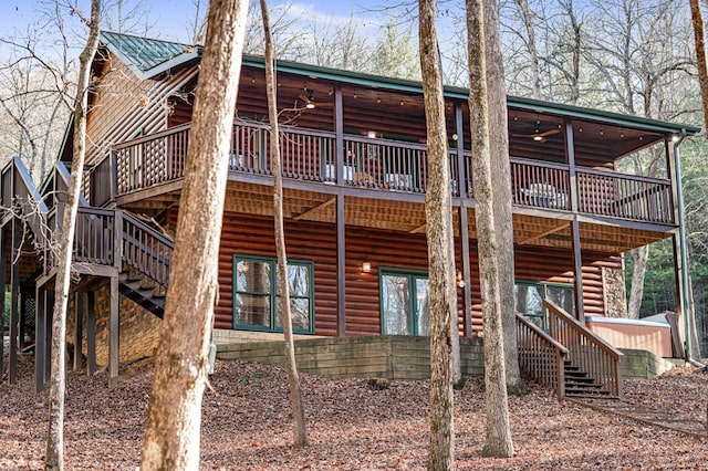 rear view of house featuring stairs, metal roof, a ceiling fan, and faux log siding