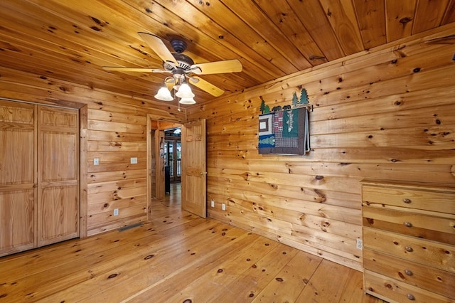 interior space featuring a ceiling fan, wood ceiling, and wood finished floors