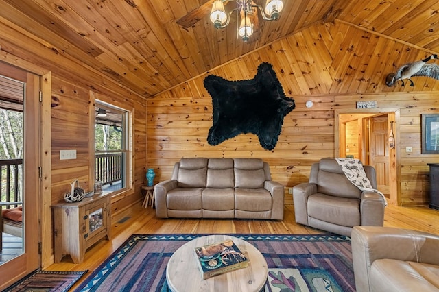 living area featuring vaulted ceiling, wood finished floors, wood ceiling, and wooden walls