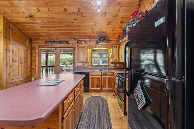 kitchen with brown cabinetry, lofted ceiling, wooden ceiling, light countertops, and black appliances