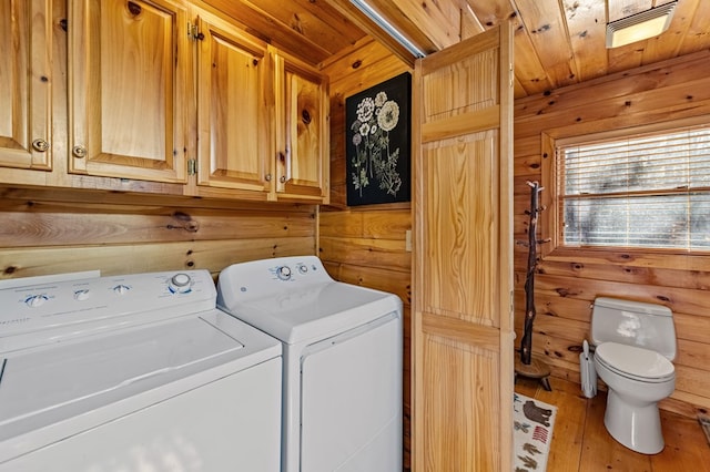 washroom featuring washing machine and dryer, laundry area, wooden ceiling, and light wood finished floors