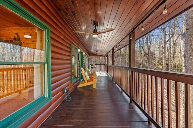 deck featuring covered porch and a ceiling fan