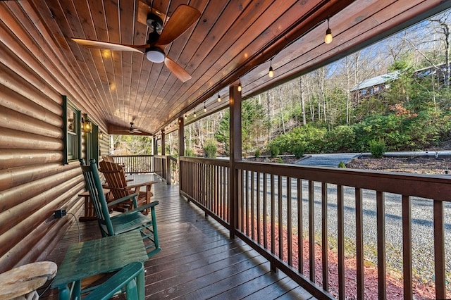 wooden deck featuring a porch and a ceiling fan