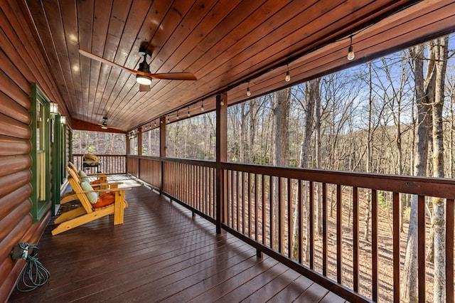 wooden deck with a ceiling fan