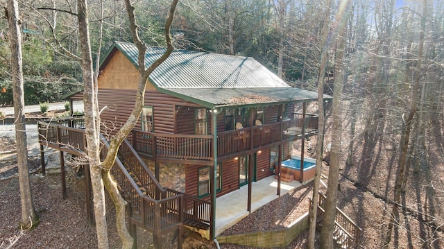 view of property exterior featuring faux log siding and metal roof