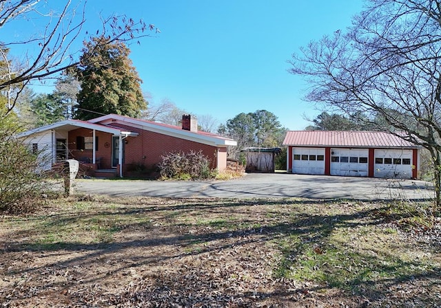 view of home's exterior with a garage and an outdoor structure