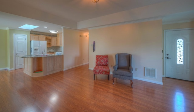 467 Greenlawn Cemetary Rd, Murphy, NC 28906 - unfurnished room featuring ornamental molding, a skylight, light wood finished floors, baseboards, and a sink