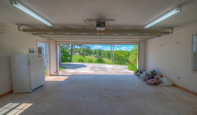 467 Greenlawn Cemetary Rd, Murphy, NC 28906 - garage with freestanding refrigerator, a garage door opener, and baseboards