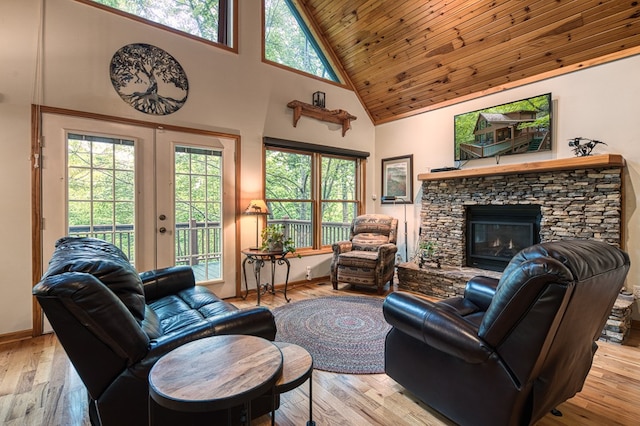 living area with high vaulted ceiling, french doors, hardwood / wood-style flooring, wood ceiling, and a fireplace