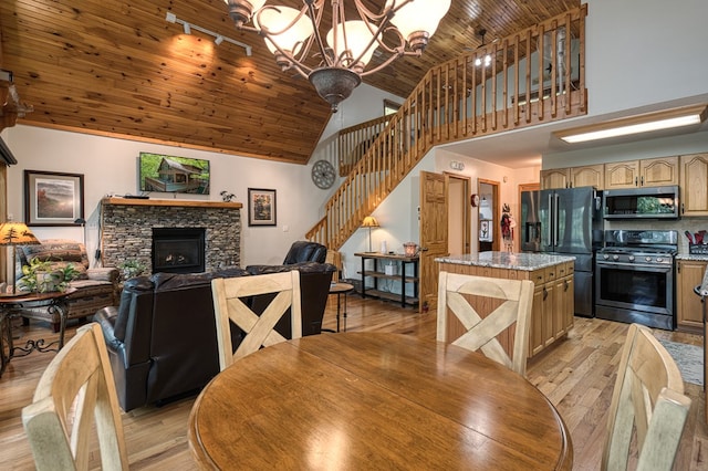 dining room with wooden ceiling, high vaulted ceiling, stairway, a chandelier, and light wood-style floors