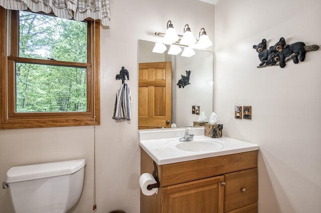 half bath featuring toilet and vanity