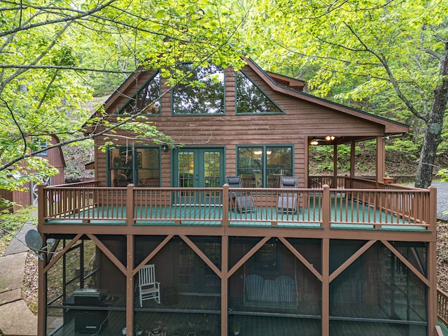 back of property with a deck and french doors