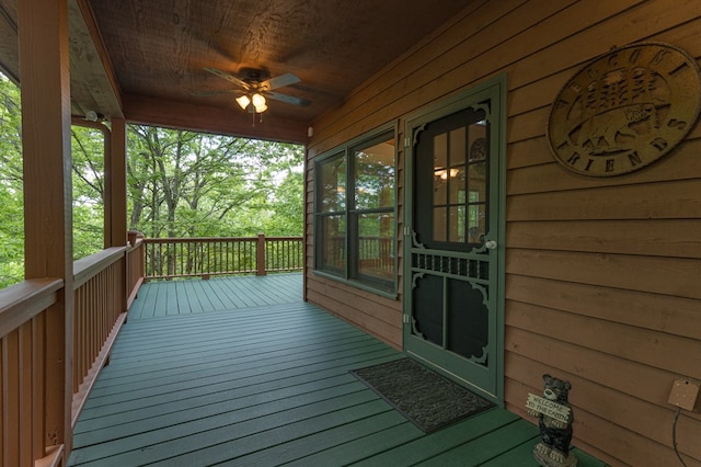 wooden deck featuring a ceiling fan