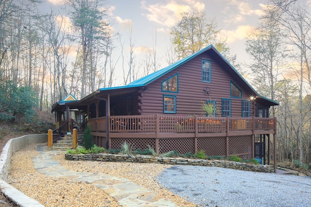 back house at dusk with a wooden deck