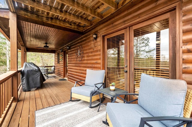 wooden terrace with area for grilling and ceiling fan