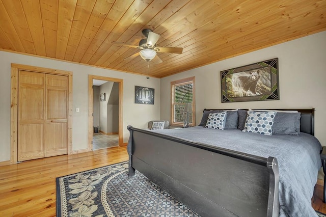 bedroom featuring ceiling fan, a closet, light hardwood / wood-style flooring, and wood ceiling