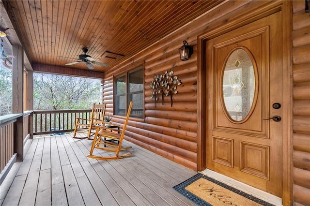 entrance to property with ceiling fan and a porch