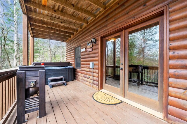 wooden terrace featuring a hot tub