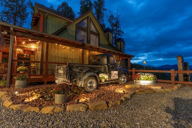 view of property exterior featuring board and batten siding and fence