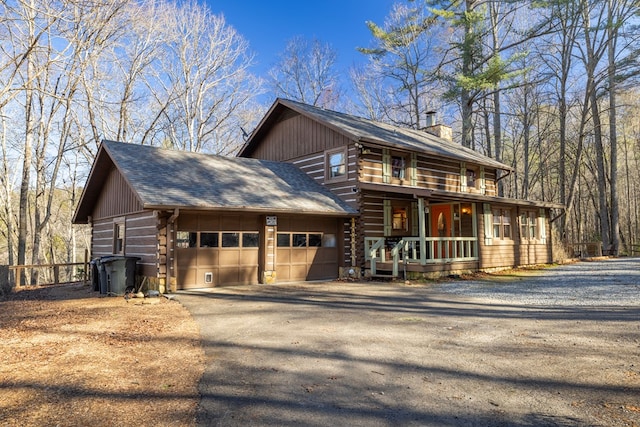 view of front of property featuring a garage and a porch