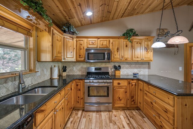 kitchen with wood ceiling, a sink, light wood finished floors, appliances with stainless steel finishes, and vaulted ceiling