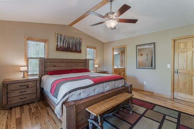 bedroom with baseboards, vaulted ceiling, multiple windows, and light wood finished floors