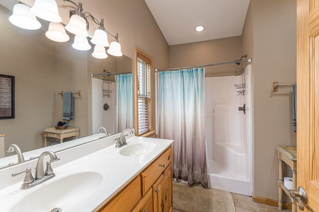bathroom with a sink, tile patterned floors, double vanity, and a shower with shower curtain