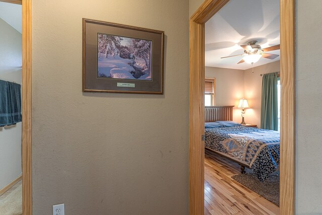 bedroom with a ceiling fan and wood finished floors