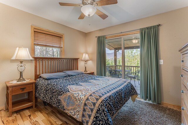 bedroom with access to outside, baseboards, multiple windows, and light wood-style flooring