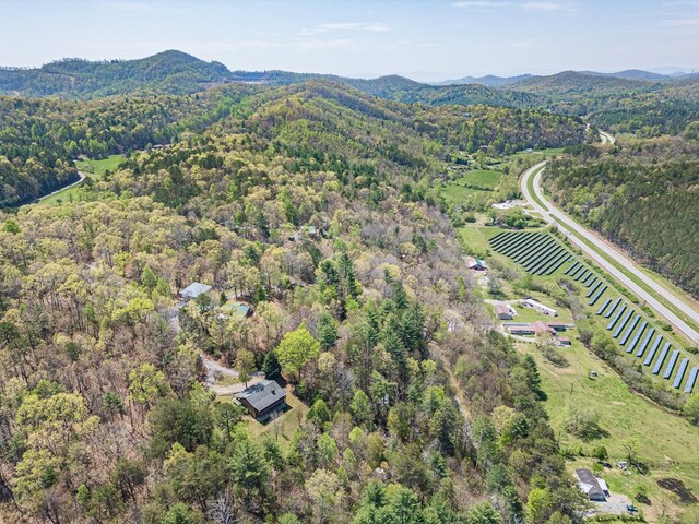 drone / aerial view featuring a mountain view, a rural view, and a wooded view
