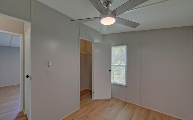 unfurnished bedroom with light wood-style floors and ceiling fan