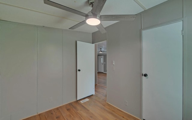 unfurnished bedroom with light wood-style floors, ceiling fan, and visible vents
