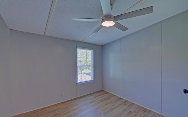 spare room with ceiling fan and light wood-type flooring