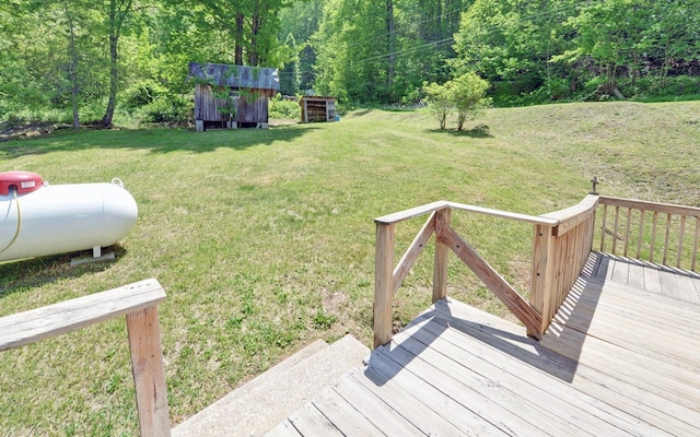 view of yard featuring an outbuilding, a wooden deck, and a storage shed