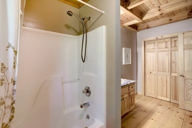 full bath featuring vanity, shower / bathtub combination, hardwood / wood-style floors, beamed ceiling, and wooden ceiling