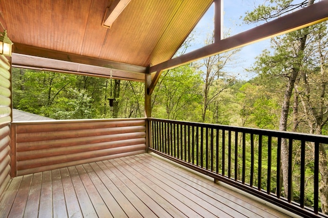 wooden deck with a wooded view