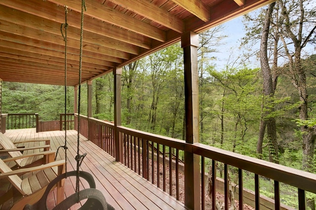 wooden deck with a forest view