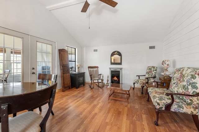 living room featuring french doors, high vaulted ceiling, light hardwood / wood-style floors, and ceiling fan