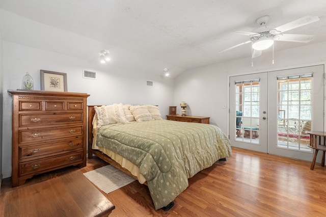 bedroom featuring hardwood / wood-style floors, lofted ceiling, ceiling fan, access to exterior, and french doors