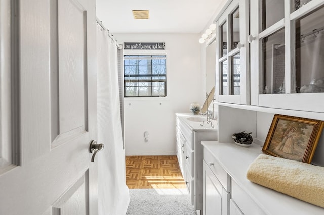 laundry area featuring light parquet flooring and sink