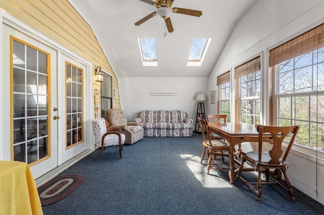 sunroom featuring lofted ceiling with skylight and ceiling fan